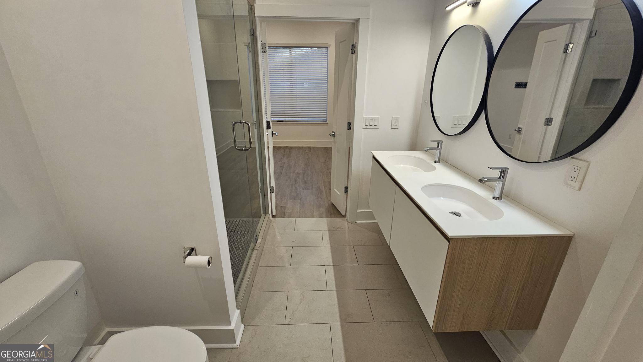 1155 Custer Avenue Southeast, Unit 101 Atlanta, GA 30316 - Photo 17 of 27 a bathroom with a sink a toilet and a mirror
