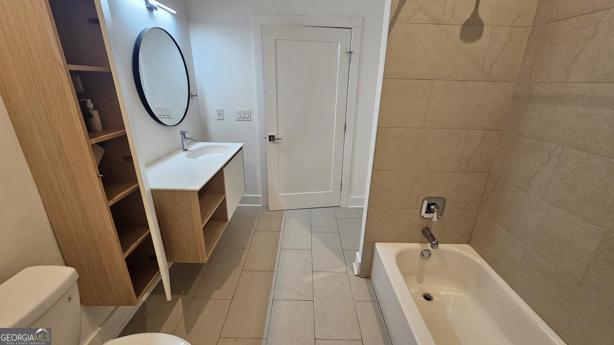 1155 Custer Avenue Southeast, Unit 101 Atlanta, GA 30316 - Photo 25 of 27 a bathroom with a sink a toilet and a mirror