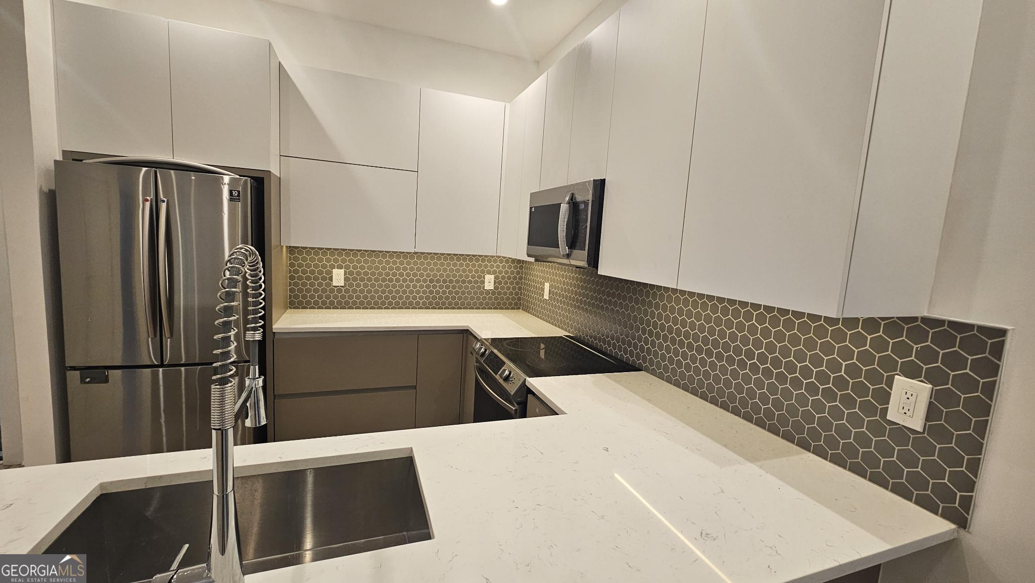 1155 Custer Avenue Southeast, Unit 101 Atlanta, GA 30316 - Photo 9 of 27 a kitchen with a sink and refrigerator
