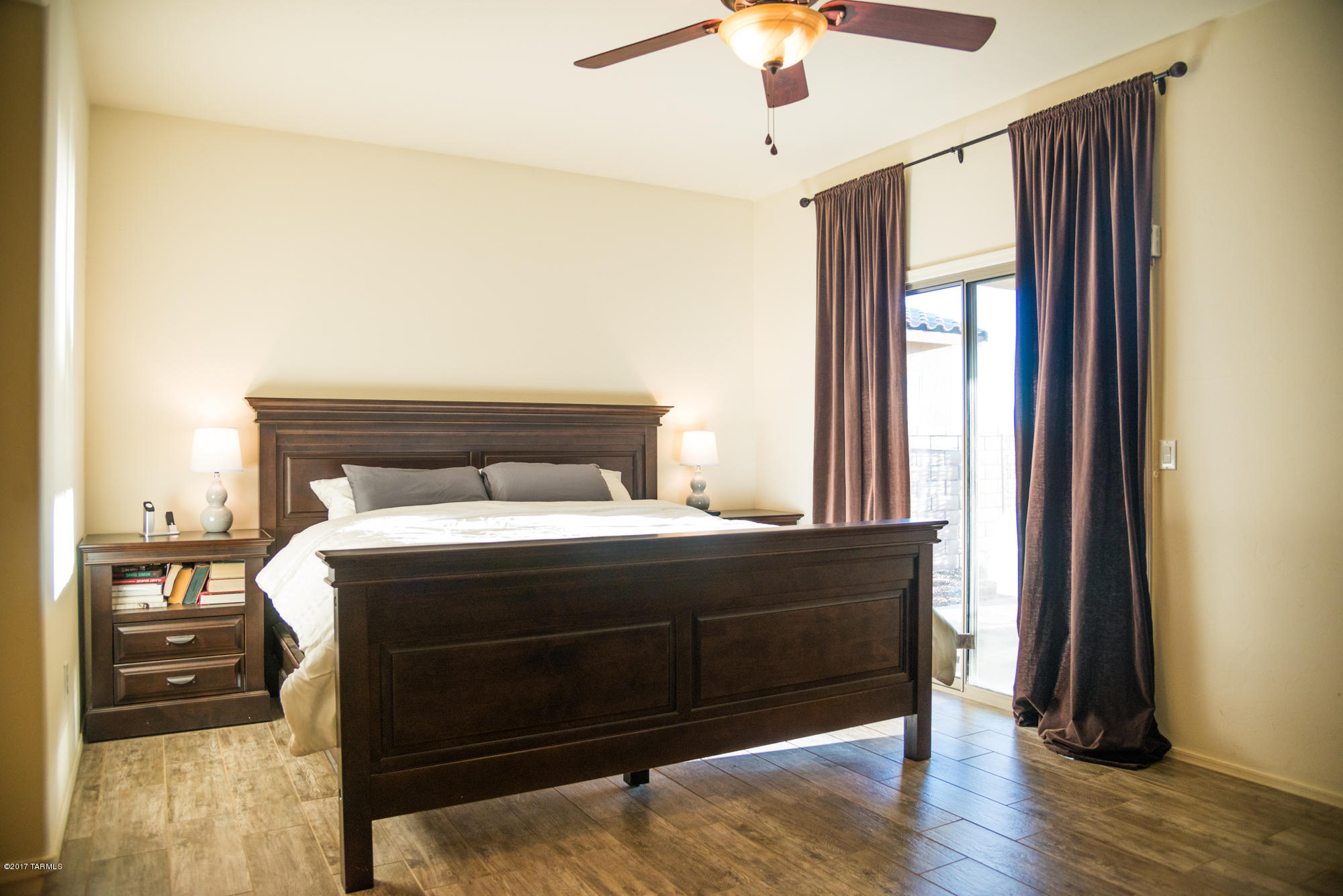 4405 West Crystal Ranch Place Marana, AZ 85658 - Photo 22 of 44 a bedroom with a bed and wooden floor