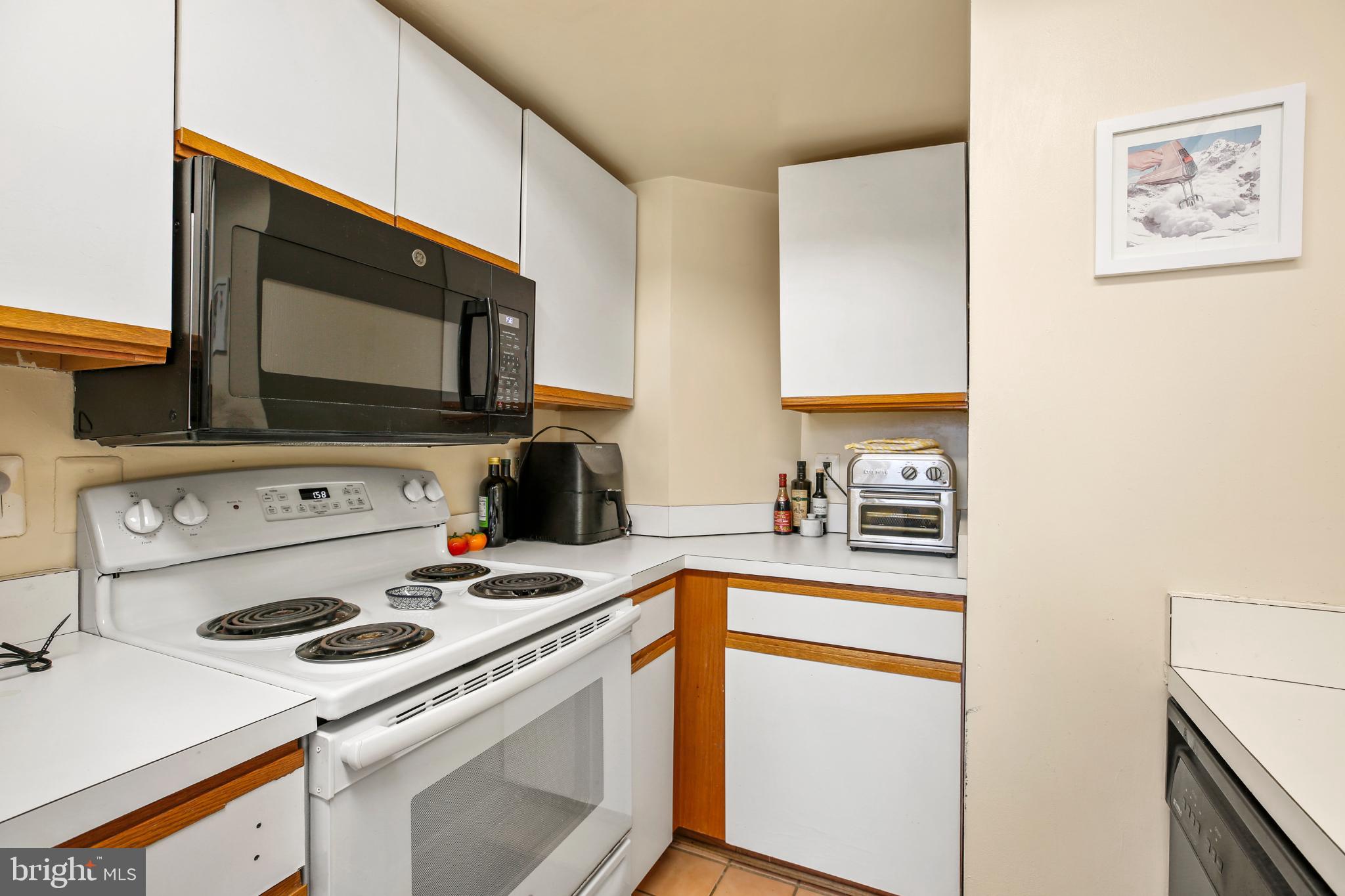 1920 S Street Northwest, Unit 404 Washington, DC 20009 - Photo 12 of 25 a kitchen with a stove and a microwave