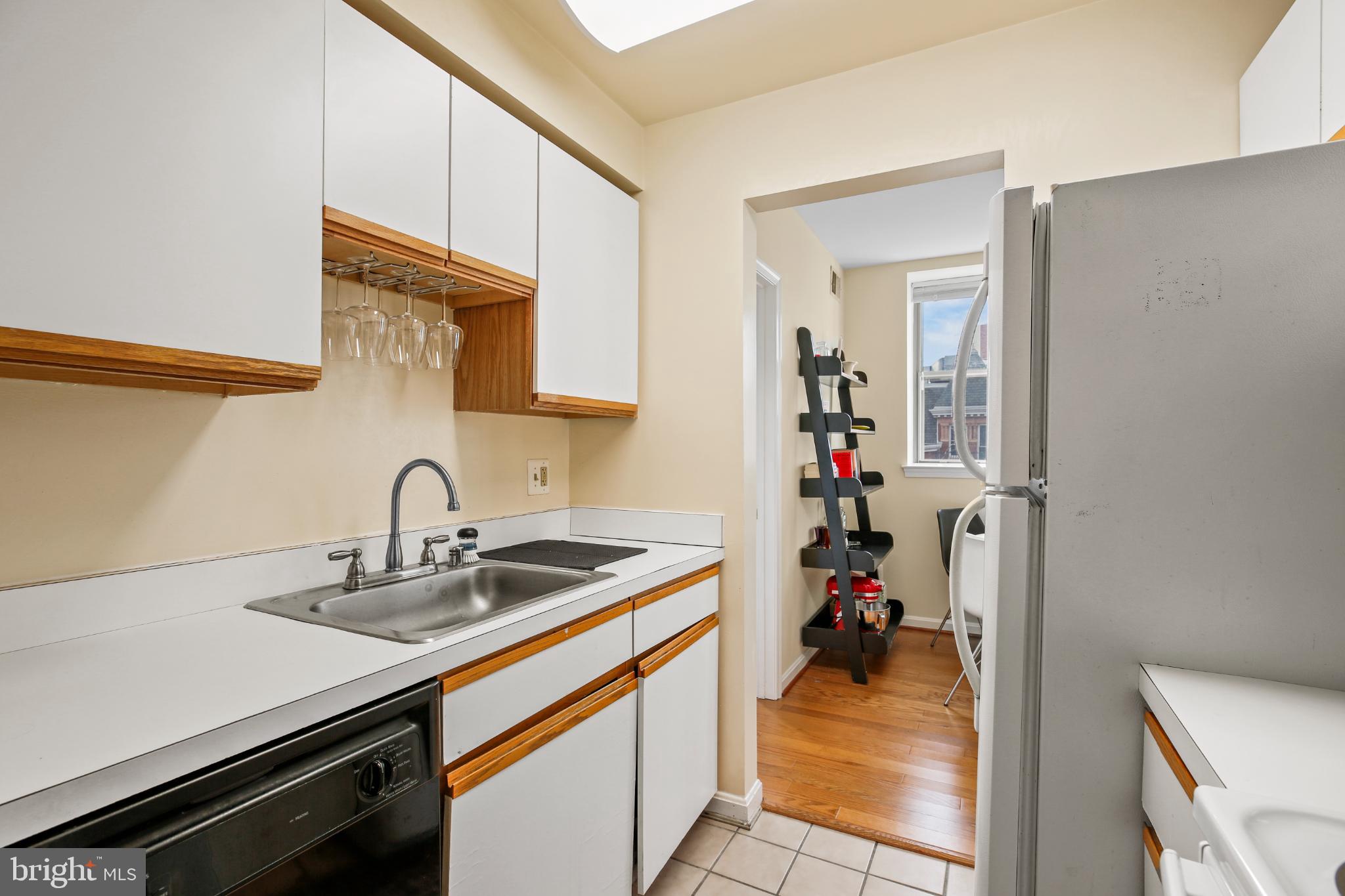1920 S Street Northwest, Unit 404 Washington, DC 20009 - Photo 13 of 25 a view of a kitchen with a sink and cabinets