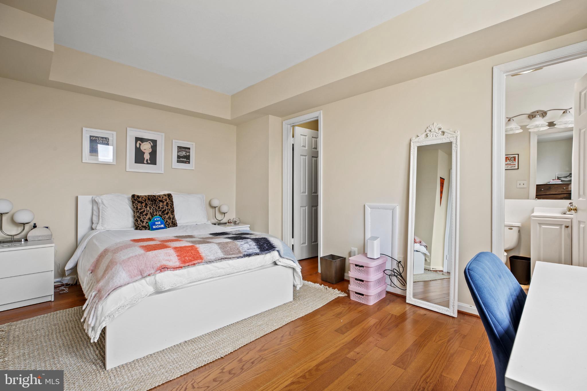 1920 S Street Northwest, Unit 404 Washington, DC 20009 - Photo 16 of 25 a bedroom with a bed and wooden floor