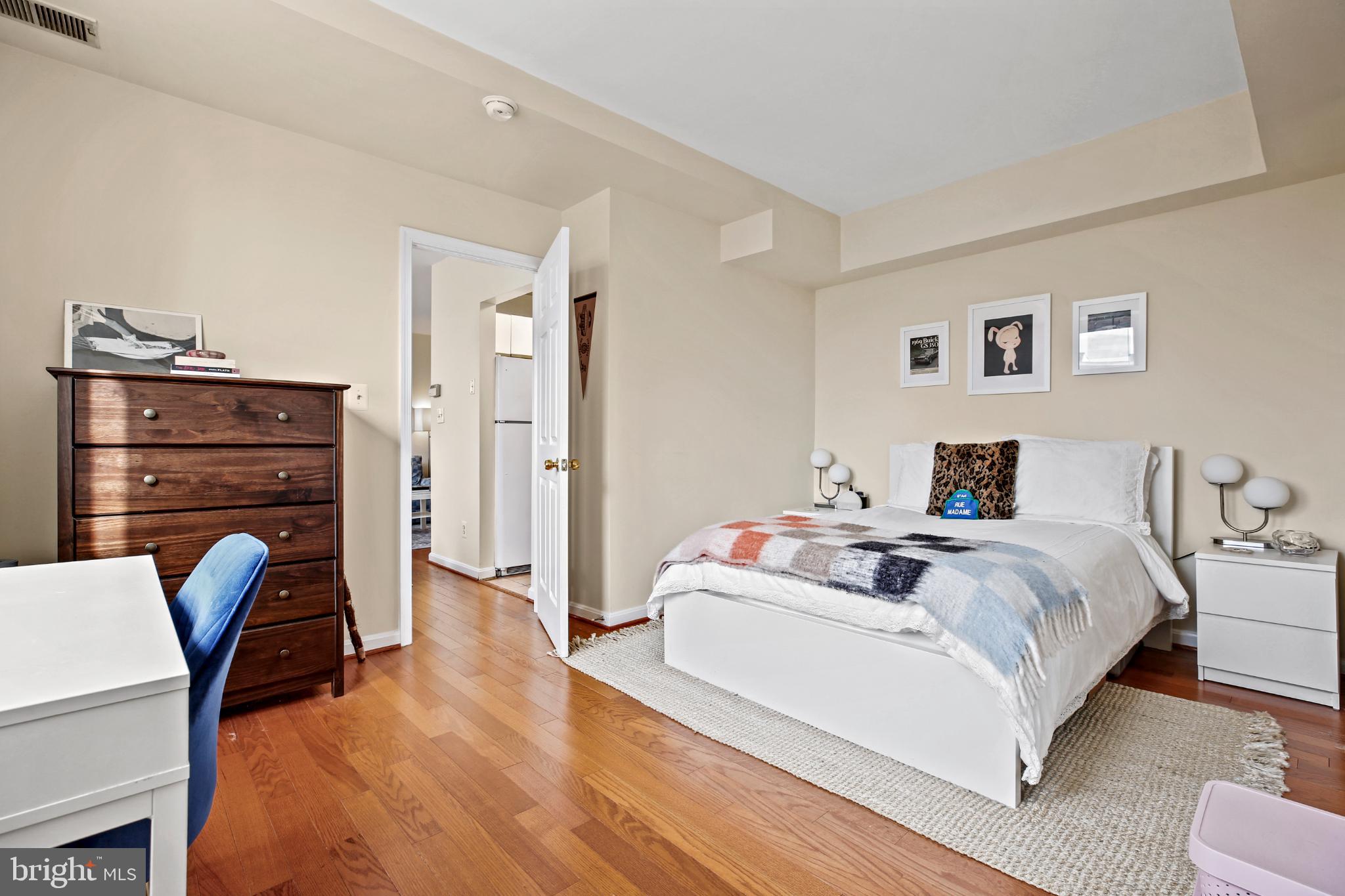 1920 S Street Northwest, Unit 404 Washington, DC 20009 - Photo 17 of 25 a spacious bedroom with a bed and a table in it