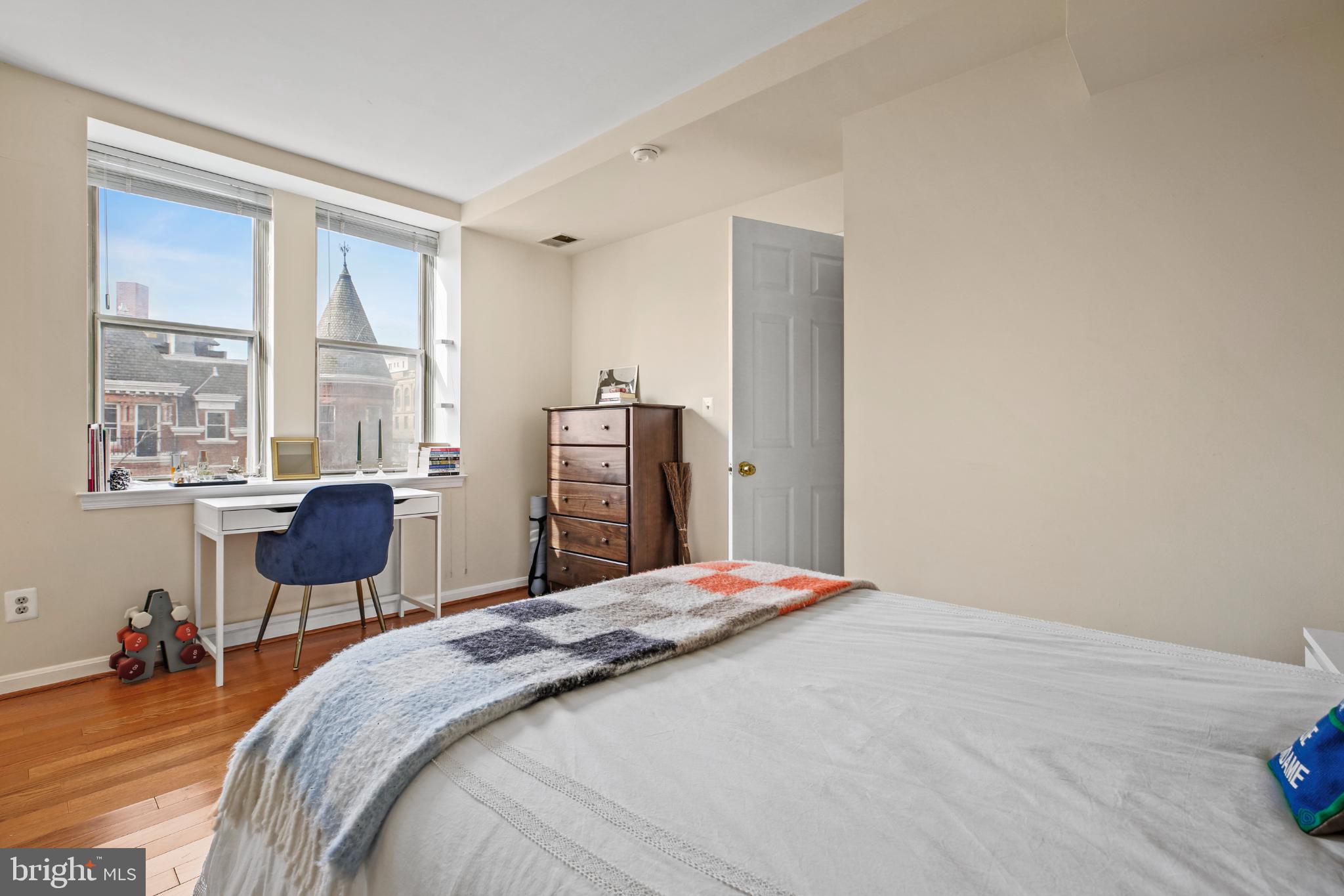1920 S Street Northwest, Unit 404 Washington, DC 20009 - Photo 5 of 25 a bedroom with a bed and a large window