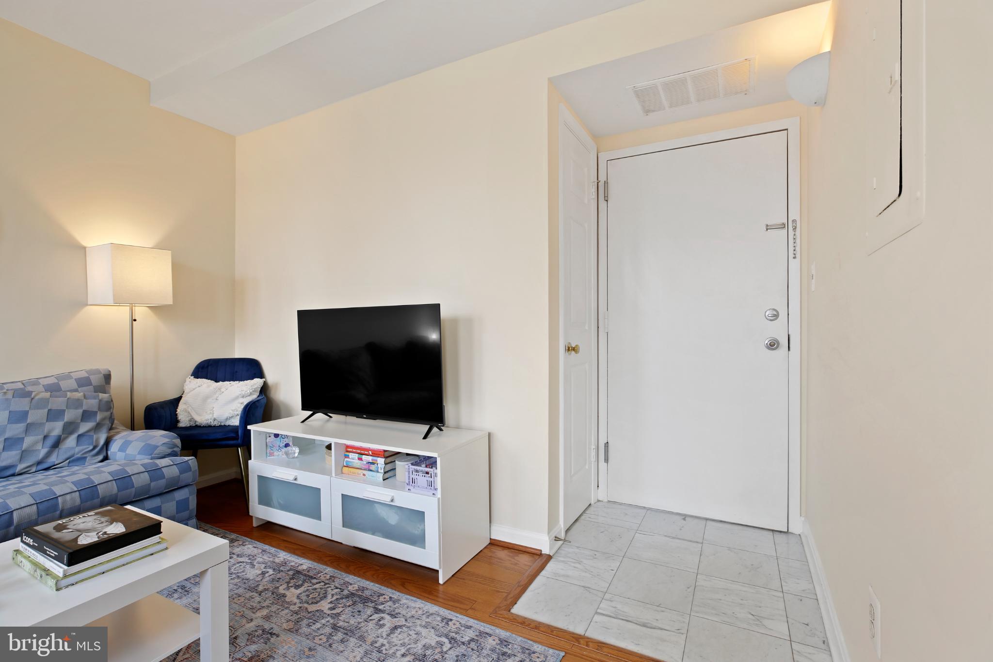 1920 S Street Northwest, Unit 404 Washington, DC 20009 - Photo 6 of 25 a living room with furniture and a flat screen tv