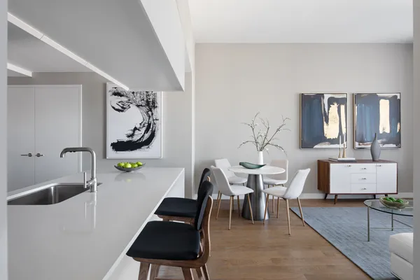 a living room with furniture and painting on the wall