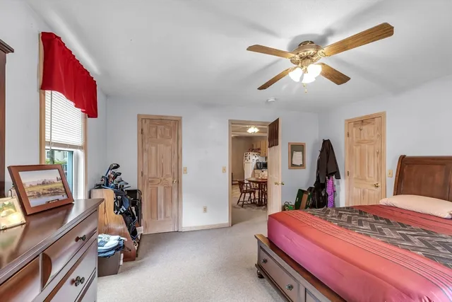 a bedroom with bed and a chandelier