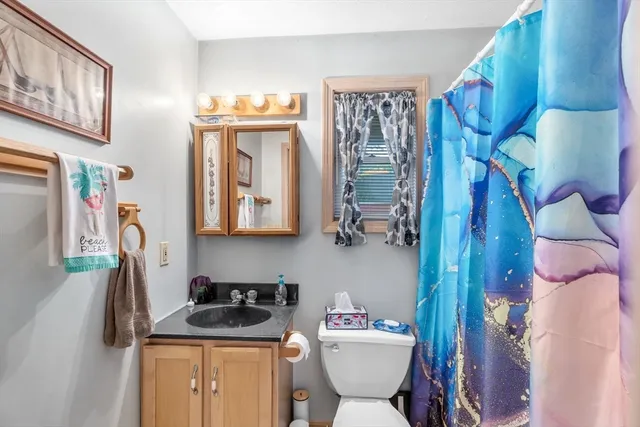 a bathroom with a toilet sink and mirror