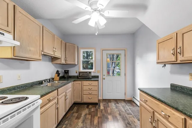 a kitchen with stainless steel appliances granite countertop a sink stove and cabinets