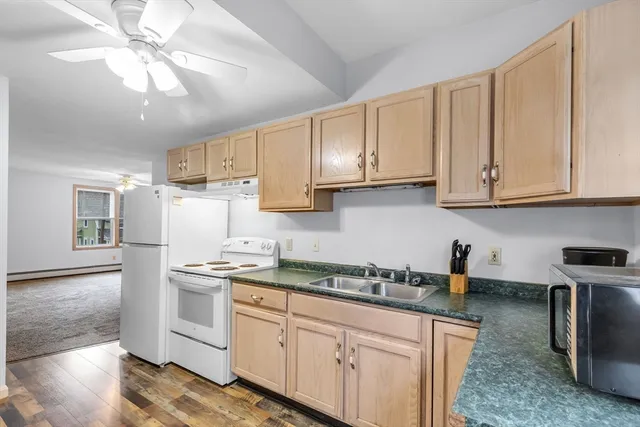 a kitchen with stainless steel appliances granite countertop a sink a stove and cabinets