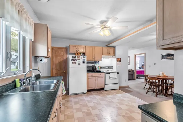 a large kitchen with a large counter top appliances and cabinets