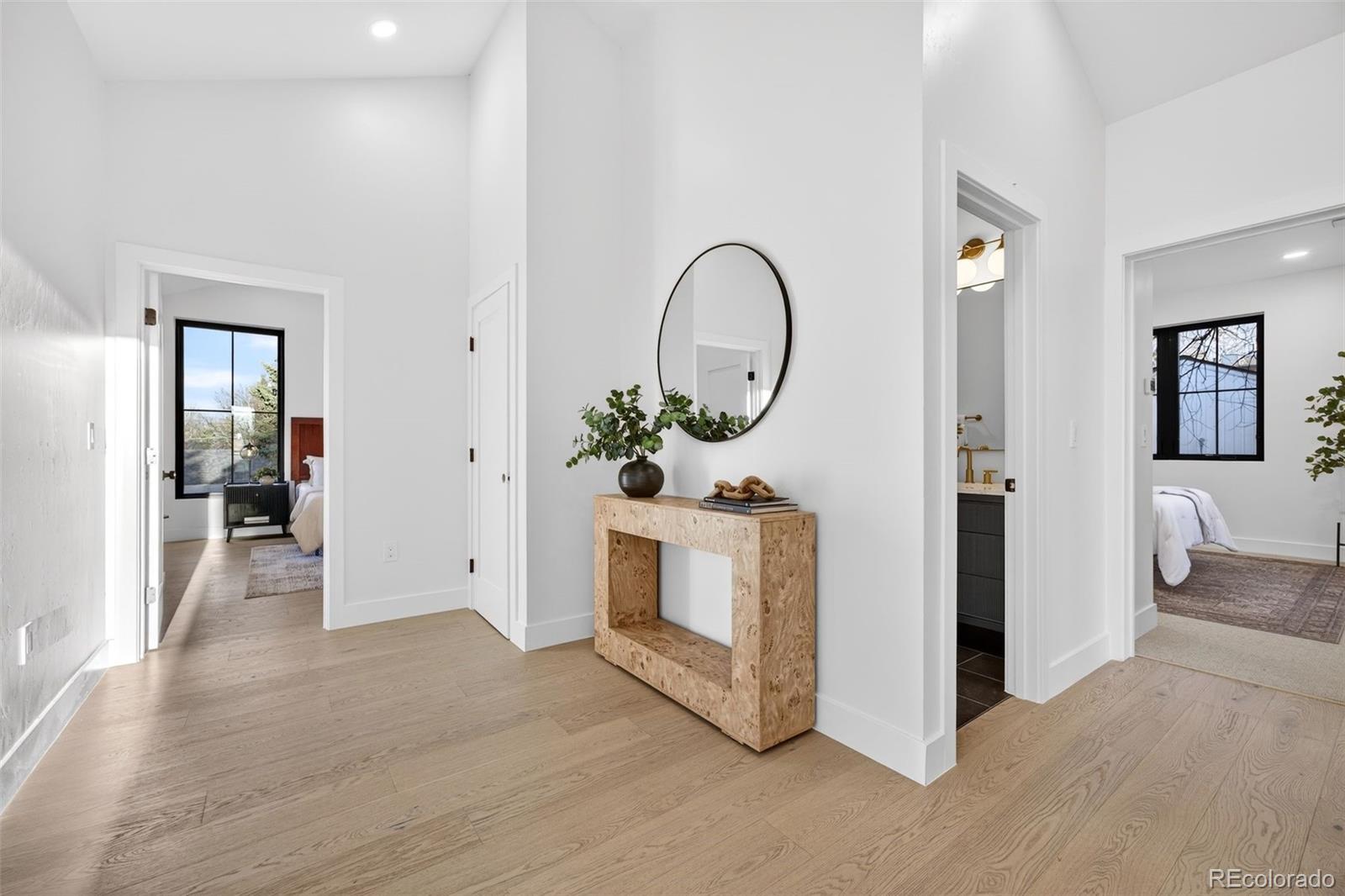 5175 Raleigh Street Denver, CO 80212 - Photo 25 of 49 a living room with furniture a mirror and a potted plant