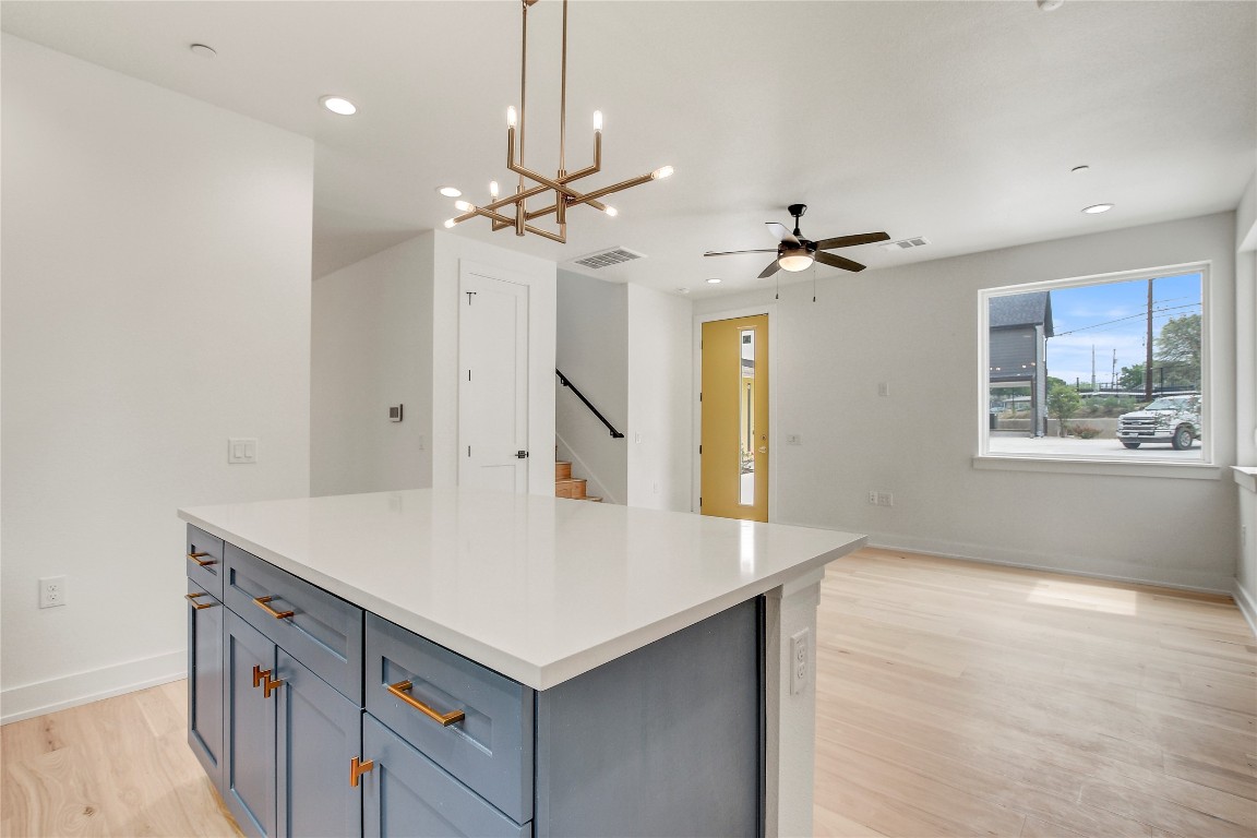 4127 East 12th Street, Unit 2 Austin, TX 78721 - Photo 21 of 28 Kitchen with a ceiling fan, light wood-type flooring, a center island, recessed lighting, and gray cabinetry