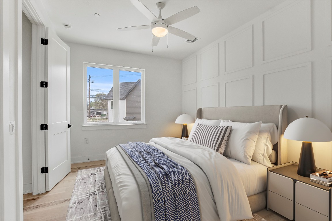 4127 East 12th Street, Unit 2 Austin, TX 78721 - Photo 23 of 28 Bedroom featuring light wood-type flooring, baseboards, and ceiling fan