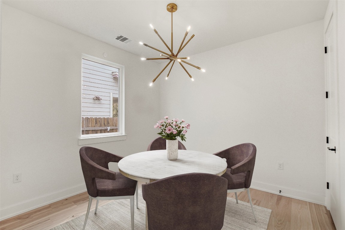 4127 East 12th Street, Unit 2 Austin, TX 78721 - Photo 3 of 28 Dining room with a chandelier, light wood-type flooring, and baseboards
