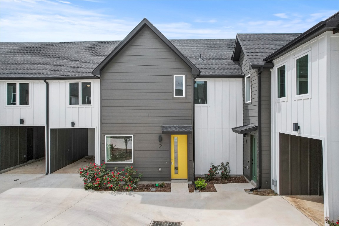 4127 East 12th Street, Unit 2 Austin, TX 78721 - Photo 6 of 28 View of front of property featuring a shingled roof and board and batten siding
