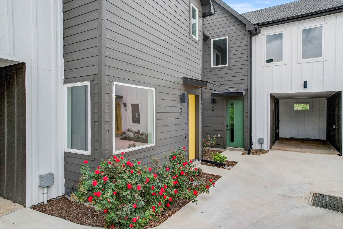 4127 East 12th Street, Unit 2 Austin, TX 78721 - Photo 7 of 28 Entrance to property with board and batten siding and concrete driveway