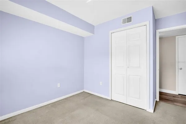 an empty room with closet area