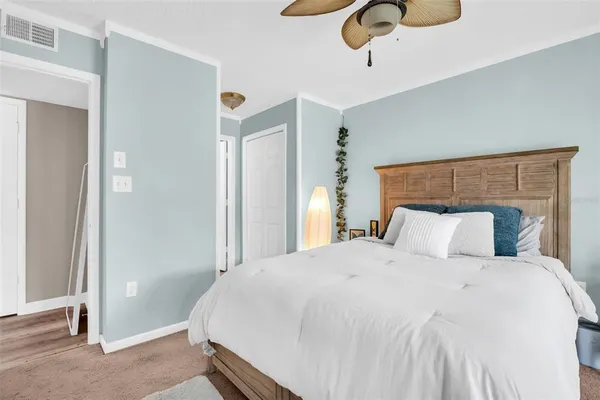 a bedroom with a bed and cabinets