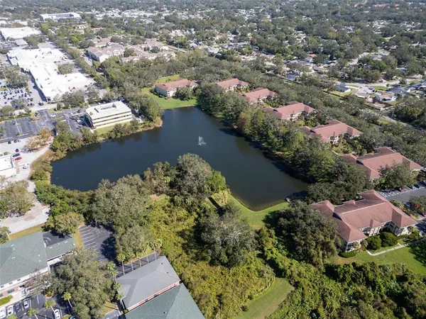 an aerial view of lake and residential houses with outdoor space