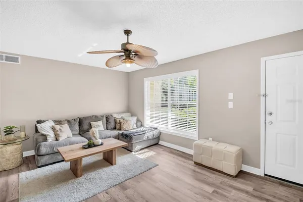 a living room with furniture and wooden floor