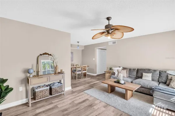 a living room with furniture and a wooden floor