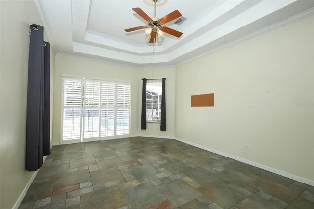 a living room with furniture two window and a fireplace
