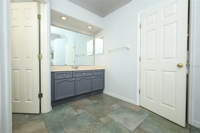 a room with painting on the wall and a window