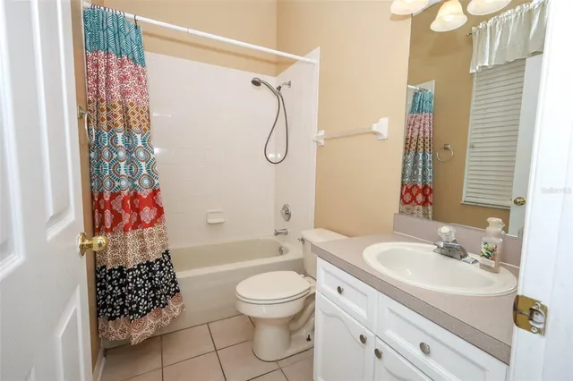 an empty room with a ceiling fan and a window