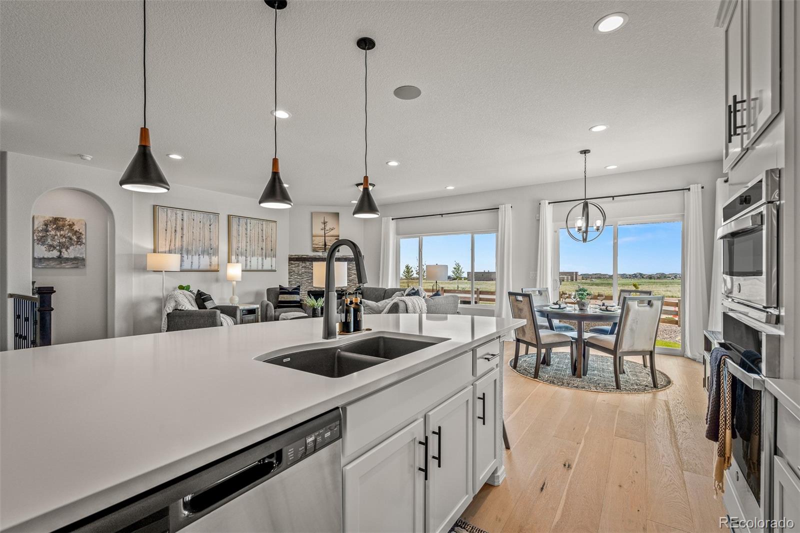 13410 New Ranch Drive Peyton, CO 80831 - Photo 11 of 50 a kitchen with counter top space appliances and wooden floor
