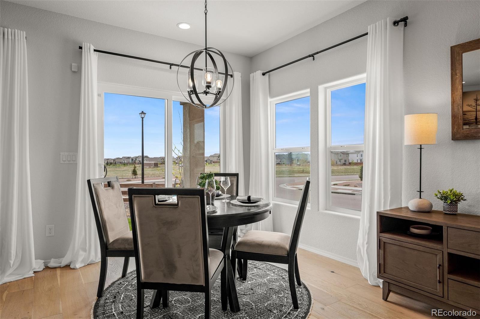 13410 New Ranch Drive Peyton, CO 80831 - Photo 17 of 50 a view of a dining room with furniture window and wooden floor