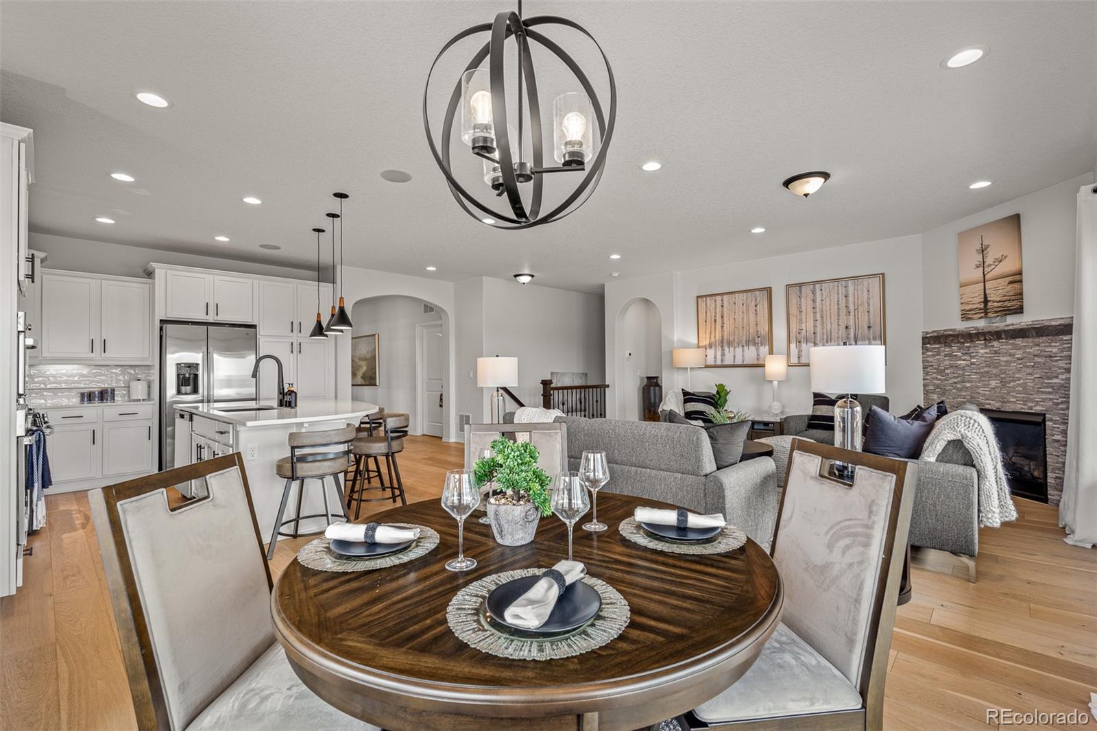 13410 New Ranch Drive Peyton, CO 80831 - Photo 19 of 50 a living room with furniture a fireplace and kitchen view