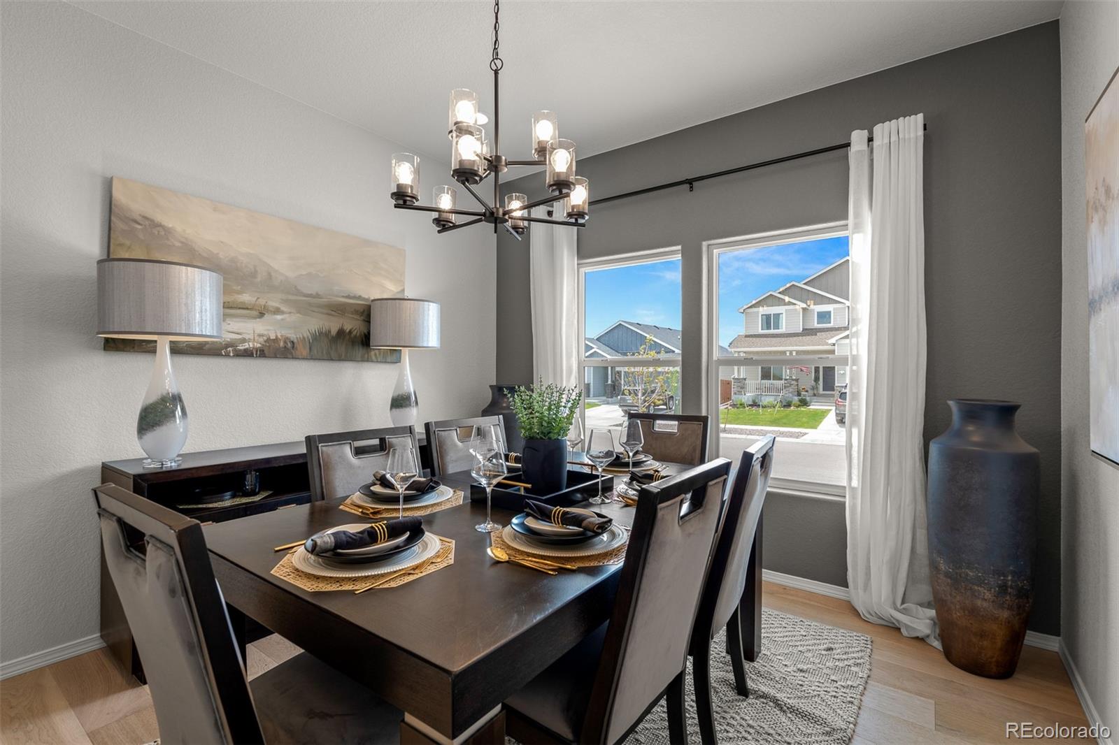 13410 New Ranch Drive Peyton, CO 80831 - Photo 29 of 50 a dining room with furniture a chandelier and window