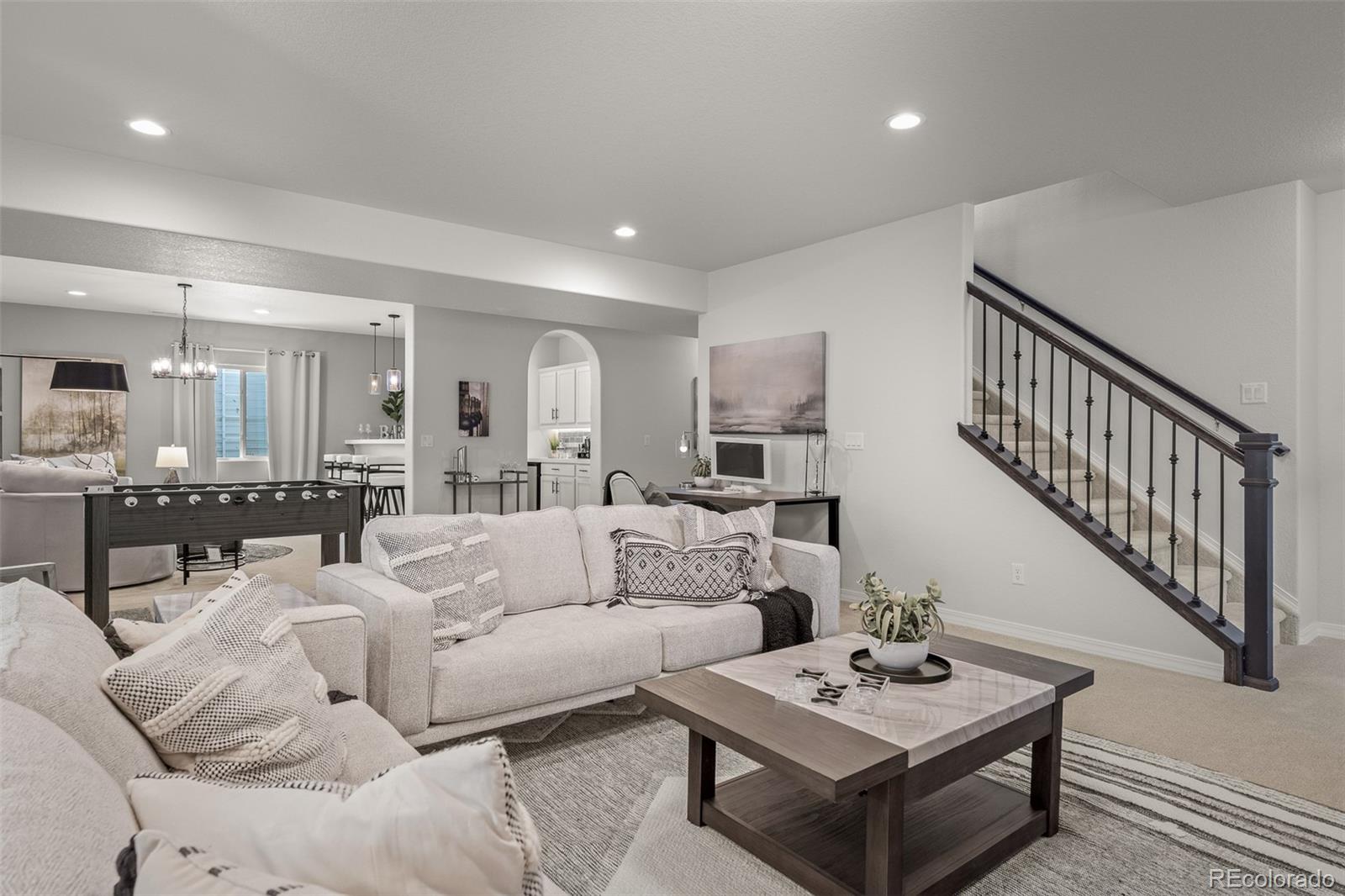 13410 New Ranch Drive Peyton, CO 80831 - Photo 34 of 50 a living room with furniture a rug kitchen view and a table