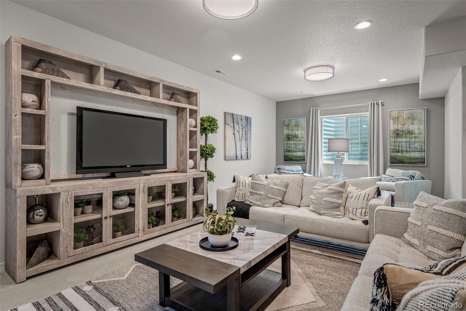 13410 New Ranch Drive Peyton, CO 80831 - Photo 35 of 50 a living room with furniture and a flat screen tv