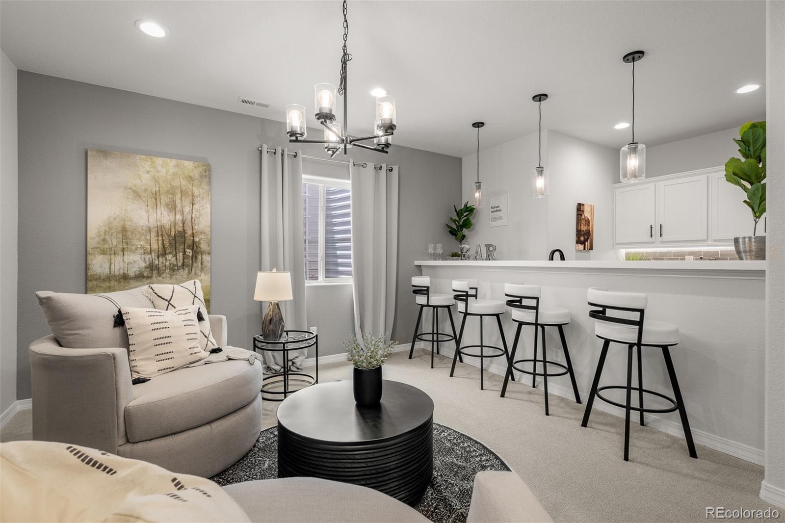 13410 New Ranch Drive Peyton, CO 80831 - Photo 38 of 50 a living room with kitchen island furniture and a chandelier