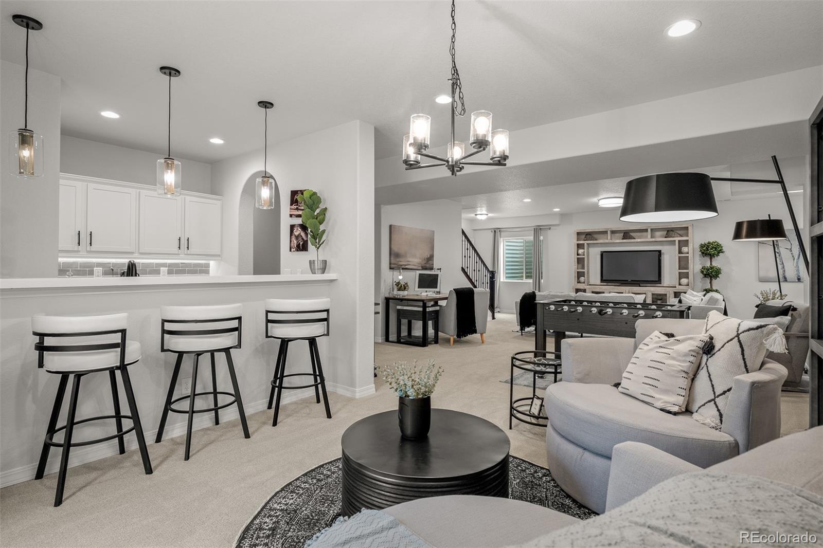 13410 New Ranch Drive Peyton, CO 80831 - Photo 39 of 50 a living room with furniture kitchen view and a chandelier