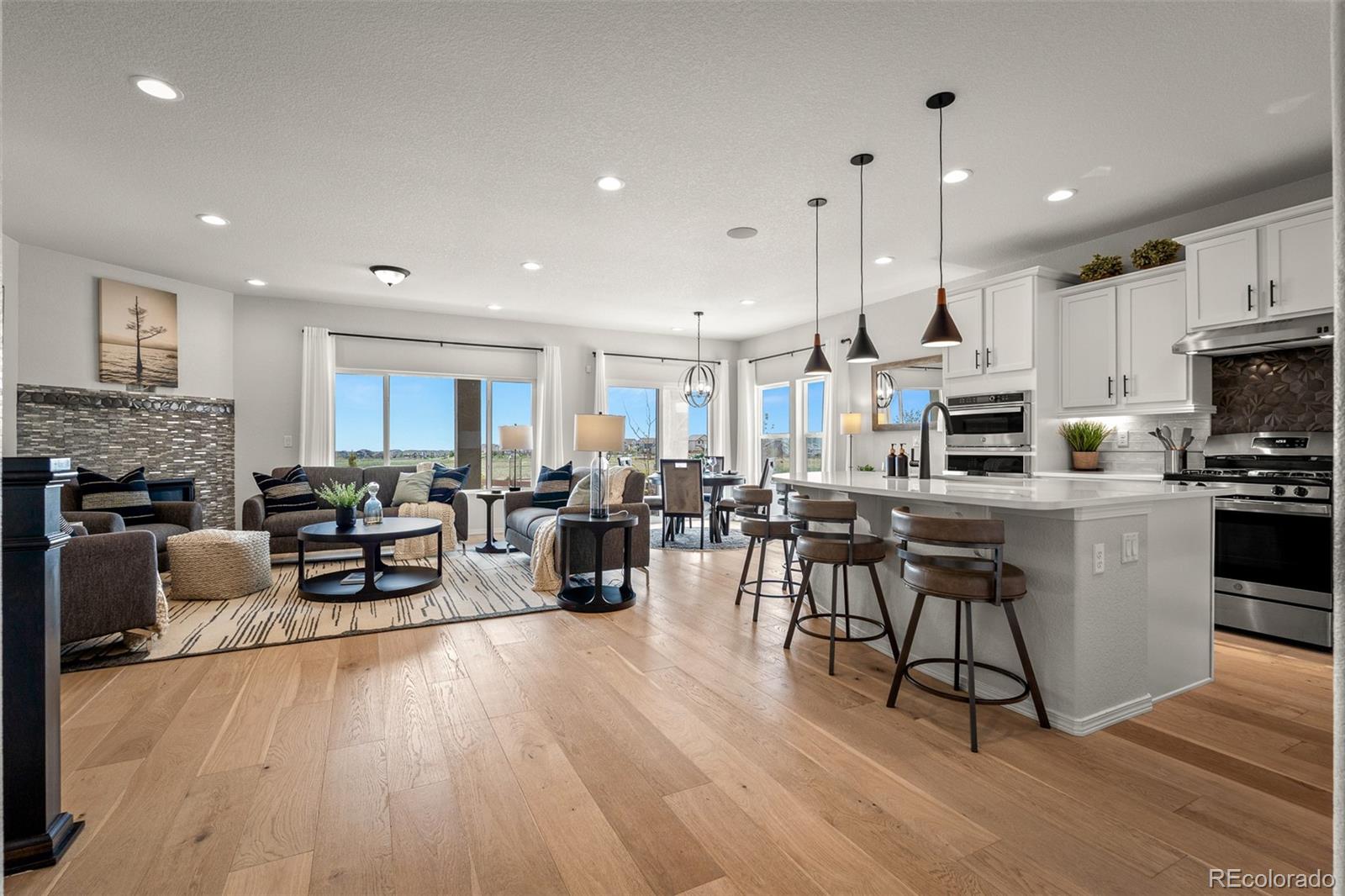 13410 New Ranch Drive Peyton, CO 80831 - Photo 4 of 50 a living room with lots of furniture and kitchen view