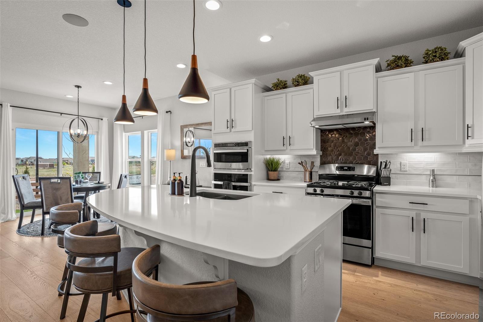 13410 New Ranch Drive Peyton, CO 80831 - Photo 5 of 50 a kitchen with a stove a sink and a refrigerator