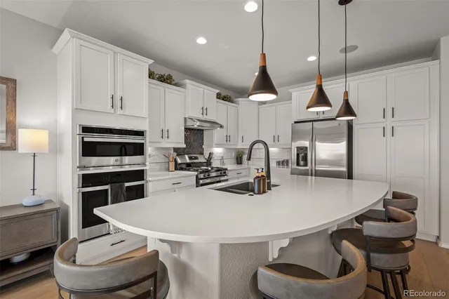 a kitchen with a table chairs stove and microwave