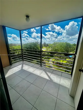 a view of a room with wooden floor and windows