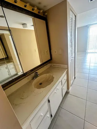 a bathroom with a sink a mirror and shower