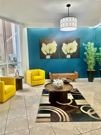 a living room with furniture flowerpot and window