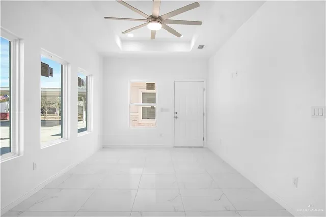 a view of a kitchen with refrigerator and a ceiling fan
