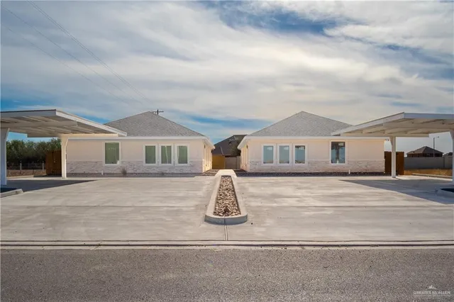 a front view of a house with parking space