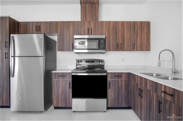 a kitchen with refrigerator cabinets and microwave