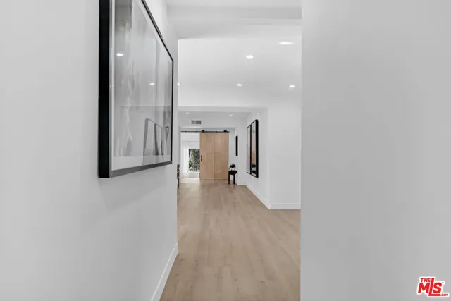 a view of a hallway with wooden floor