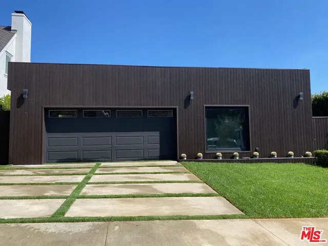 a living room with fireplace furniture and a potted plant