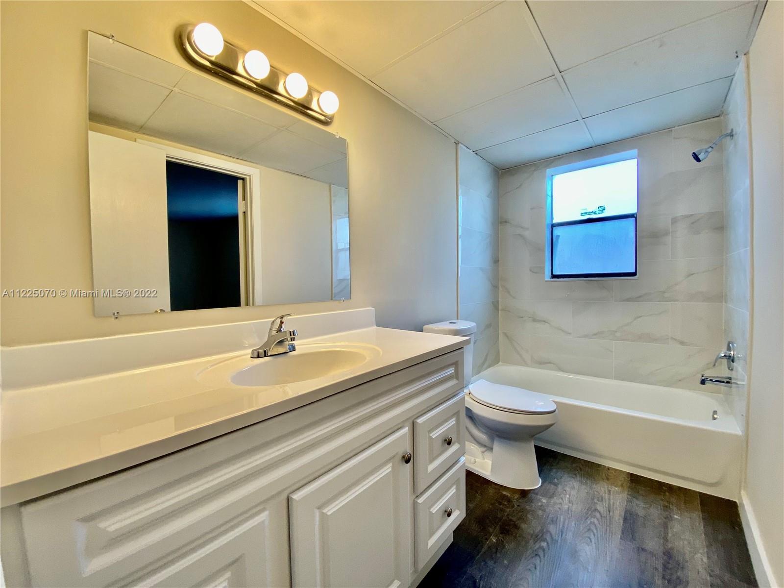a bathroom with a sink a toilet and bathtub